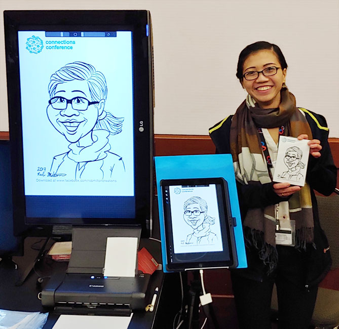Lady with her Digital Caricature displayed on screen and in print at event.