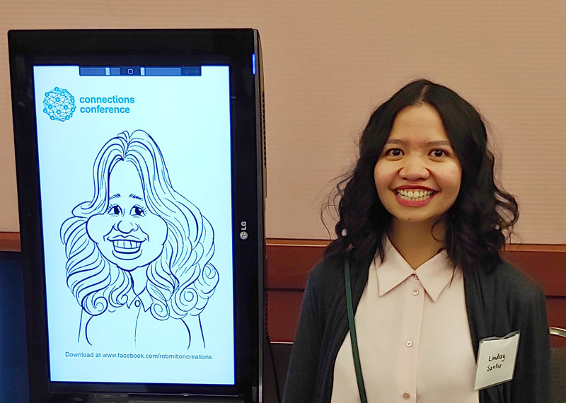 Lady beside her on-screen digital caricature.